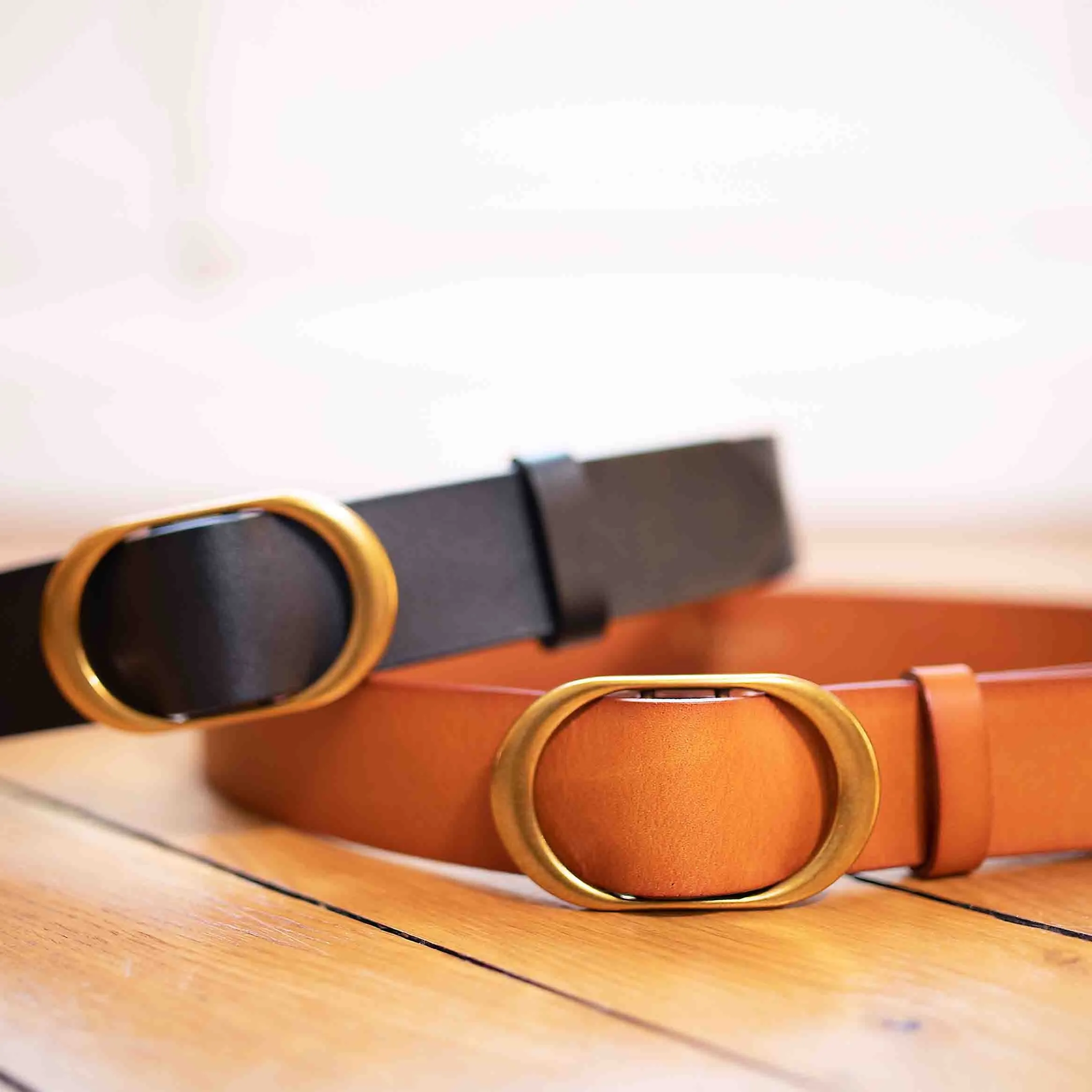 Tan and black leather buckle belts